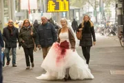 Dagmar Schwittay (Ilse Strambowski) irrt in einem blutbefleckten Brautkleid durch Köln (im Hintergrund Komparsen). Hat die an Alzheimer erkrankte Seniorin den Mord an der Richterin begangen und dann das Brautkleid gestohlen?