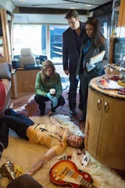Richard Castle (Nathan Fillion, 2.v.r.), Kate Beckett (Stana Katic, l.) und Lanie Parish (Tamala Jones, r.) übernehmen die Ermittlungen im Mord an dem bekannten Sänger James Swan (Hunter Jackson, liegend) ...
