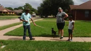 Adopters with Yahtzee outside of home during a home check.