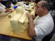 Mauro works on the elephant house building for the Bronx Zoo cake.