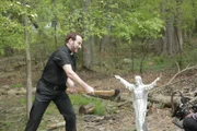 Eddie Sexton uses an ax to cut a Jesus statue.