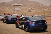 Cars are lined up in preparation for hitting the driving course at Willow Springs