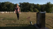 Woman visiting graveyard
