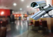 security CCTV camera or surveillance system with restaurant on blurry background
