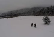 Bam Brown and Matt Brown cross the snow.