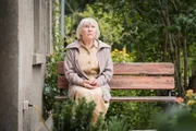 Wilma (Jutta Wachowiak) sitzt vor ihrem Haus, nachdem sie das Krankenhaus verlassen hat.