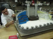 Buddy airbrushes the Medieval Times Cake, as seen in 'Cake Boss' series 3 featured in episode 307.