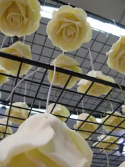 Sugar roses for a birdcage wedding cake hang to dry.