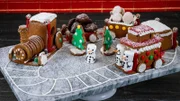 Contestant Lana Witherspoon's dish Gingerbread with Honey and Molasses, Hazelnut French Macaron with Chocolate Hazelnut Buttercream, and Chocolate Hazelnut Cookie during the second round, The Display Challenge, "Christmas Cookie Train", as seen on Christmas Cookie Challenge, Season 2.