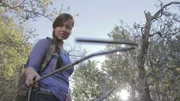 Hannah Lockhart holding a snake hook while searching.