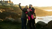 RACHEL, JON, and LUCY take a selfie on the cliffs.