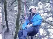 Shaun Sears, on a rescue mission, hangs from ropes in a tree.