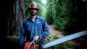 Nate holding a chainsaw.