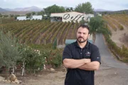 Doffo Winery owner, Damian, stands outside in front of his property in Temecula, California.