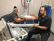 Dr. Lavigne, along with vet tech assistant Kayla performing an ultrasound on Sky, the pit bull.