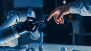 Futuristic Robot Arm Touches Human Hand