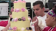 Buddy Valastro and Jessica Bacchus work on the flower cake.