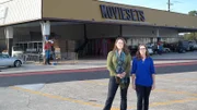 Owners Kristy and Sarah stand in front of their business, Moviesets in New Orleans, Louisiana, as seen on Food Network's Mystery Diners, Season 9.