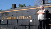 Dave, owner of Fillmore and Western Railway, in Fillmore, Calif., stands outside on train car, as seen on Food Network's Mystery Diners, Season 9.