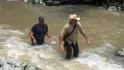 EJ Snyder and Jeff Zausch wading through water.