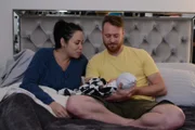 Russ and Pao hold their new baby, Axel