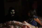 Young Adriana wakes up in fear after her brother scares her in the terrifying mask.