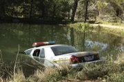 NCIS searches for a petty officer suspected of assault who escapes when the sheriff transporting him crashes into a lake.