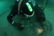 Underwater dredger  digging through cobble.