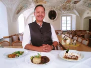 Wirt Rolf Holthausen präsentiert das Menü des Tages in der Klosterschenke Weltenburg: Wildgulasch und der typische Apfelstrudel mit Vanillesauce.