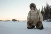 Heimo kneeling in the snow.