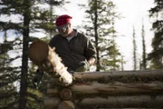 Heimo working on his log cabin.