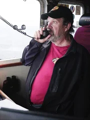Monte, Relief Captain of the Wizard, at the helm talking to the crew over the hailer.