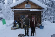Ray and wife outside cabin.