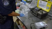 CBP Officers at the Miami International Mail Facility discover GBL, a date rape drug, in a package from Europe. (National Geographic/Lucky 8 TV)