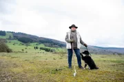 Heidi Sattes-Müller mit ihrem Hund auf der Weide.