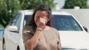 Tania crying outside of house.