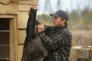 Dustin skinning a moose leg.