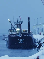 Time Bandit covered in snow at dock.