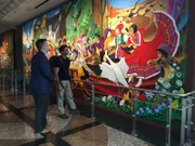 Rob Nelson examines a mural in the Denver International Airport with Heath Montgomery.