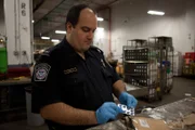 Customs and Border Protection officer Antonio Condello investigates suspicious products in the airport mailroom. (Photo Credit: National Geographic Television)