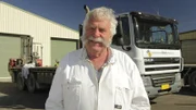 Lindsay Bourke - master beekeeper for 'Australian Honey Products' - with truck at Sheffield Honey Farm, Tasmania