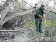 Rio Grande Valley, Texas, USA: Supervisory Border Patrol Agent David Maibaum holding a shovel as he searches the area for hidden underground bunkers that may have drugs stashed in them.