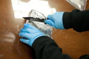 El Paso, TX: An officer cutting open a confiscated package. Drugs which have been seized by the Customs and Border Protection agency will be delivered to the Drug Enforcement Administration.