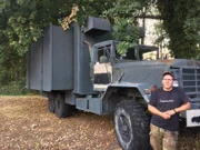Stephan Becker next to a M942 AM General Militär-Truck