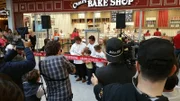 Ribbon cutting ceremony at bakery opening.
