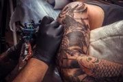 Tattoo artist doing a tattoo