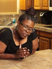 Cynthia leans over kitchen island