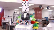An agent car cake with the boss in a Monte Carlo outfit and martini glass, plus playing cards, tokens and dice.