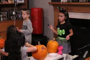 Bella and her friends decorate pumpkins and wait for the cake to arrive.