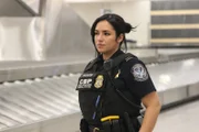 Officer Valentin on guard for passengers coming through baggage claim. (National Geographic/Lucky 8 TV)